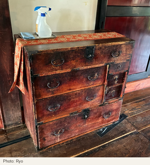 A wooden chest with wide drawers and smaller compartments on the right.