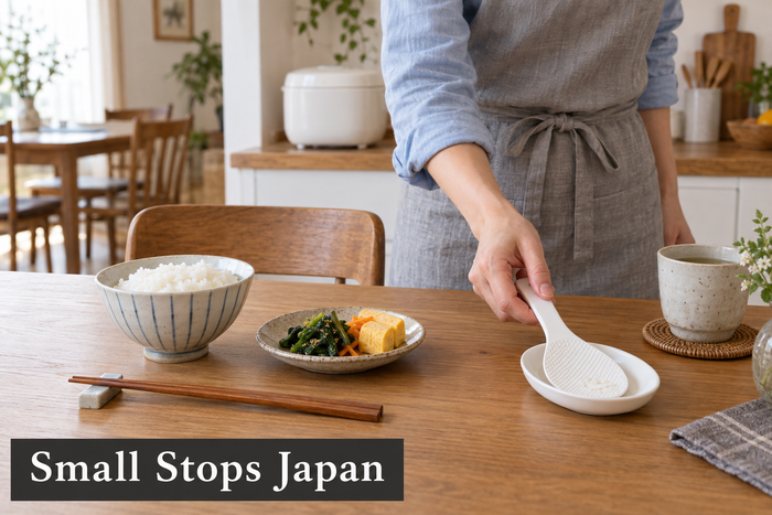 Illustration of an adult placing a white rice paddle on a small clean dish beside a filled rice bowl and chopsticks on a dining table.
