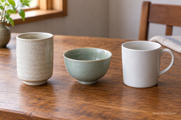 A tall handleless teacup, a low bowl-shaped teacup and a handled mug shown together.