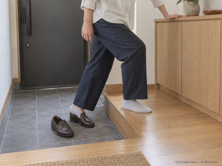 AI illustration of an adult with one socked foot on a raised wooden floor and the other foot partly inside a shoe on the lower tile.