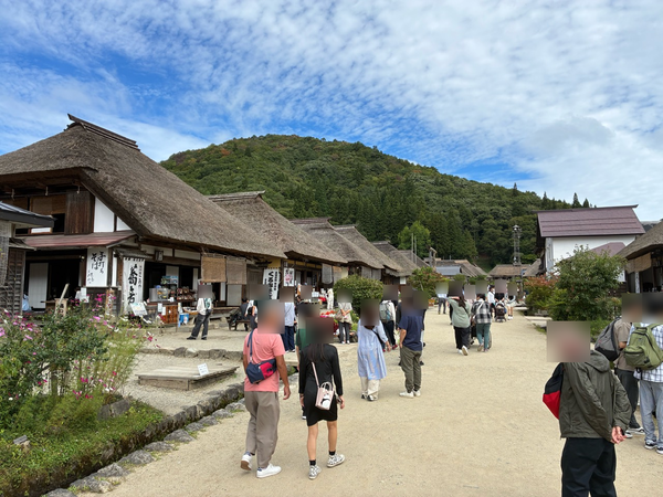 Thatched roofs receding along a street in Ouchi-juku.